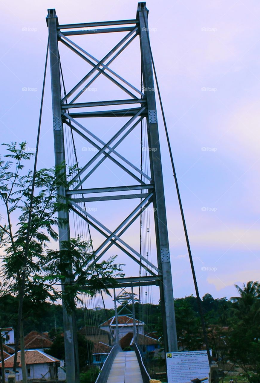 This bridge pole is for a suspension bridge that connects the two villages and only finished work after the previous bridge was swept away when the flash flood disaster struck in several areas.