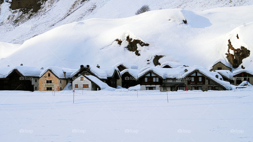 Alpine village submerged and isolated from the snow