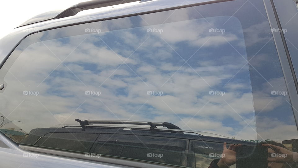 sky reflection in car window