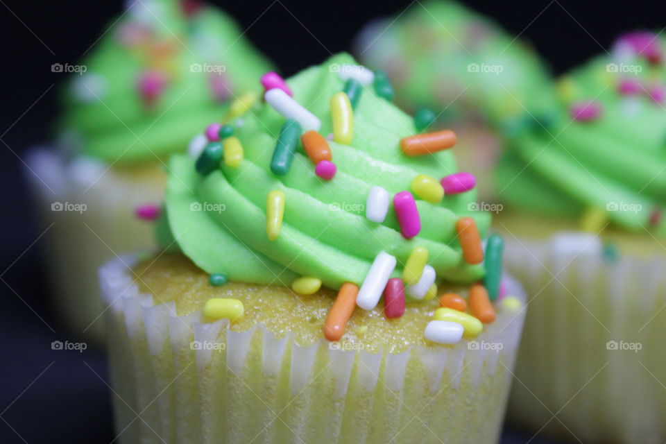 Vanilla cupcakes with green frosting
