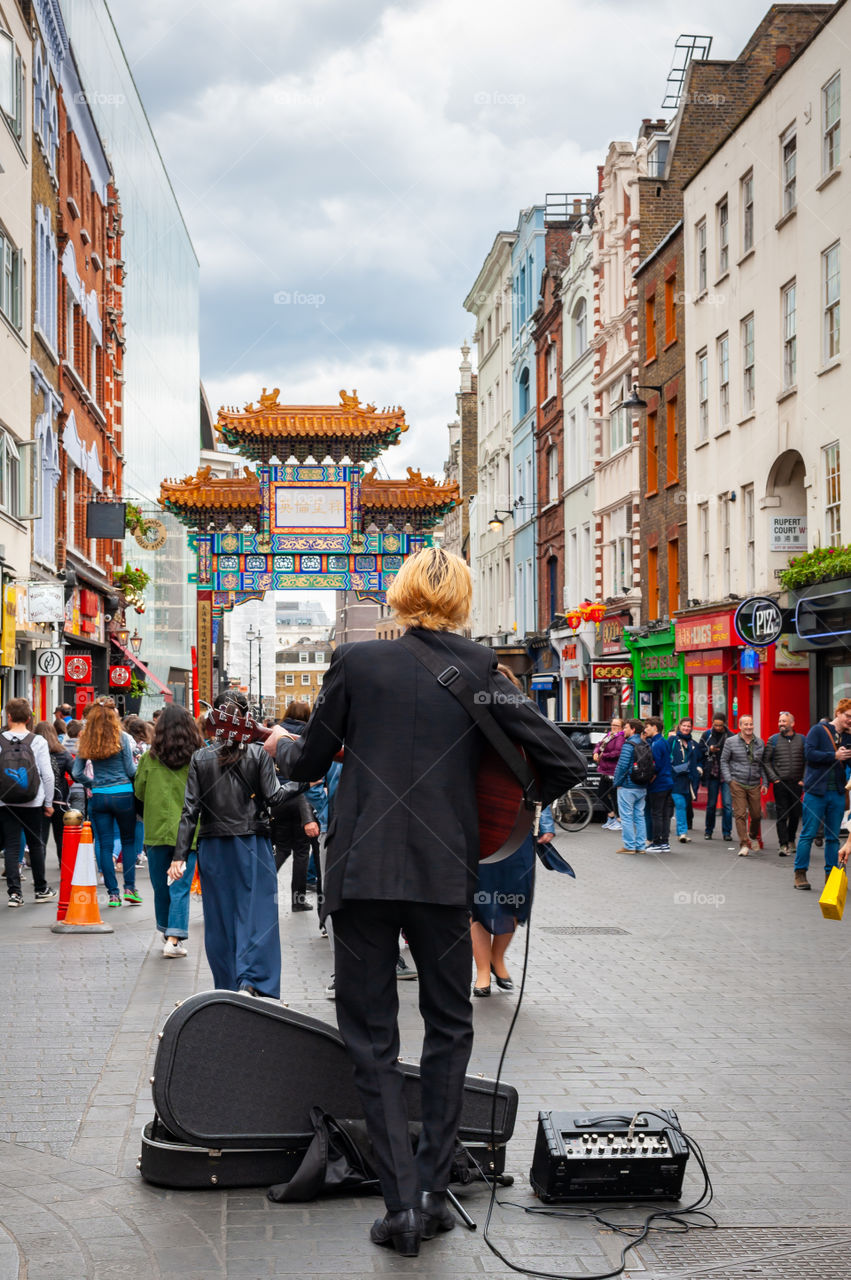 Busker in the Soho, Chinese district in London's downtown. UK