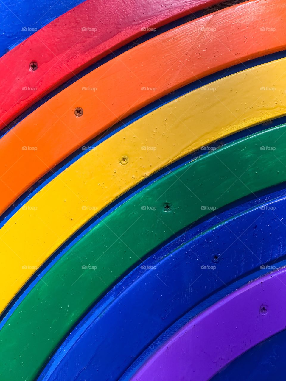 Close-up rainbow of wooden boards on a blue background