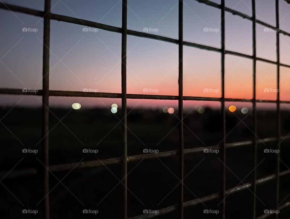 night view from a net. Blowing light. Blur lighting in night and with a window view. beautiful window view of evening, Evening view and it's Beauty