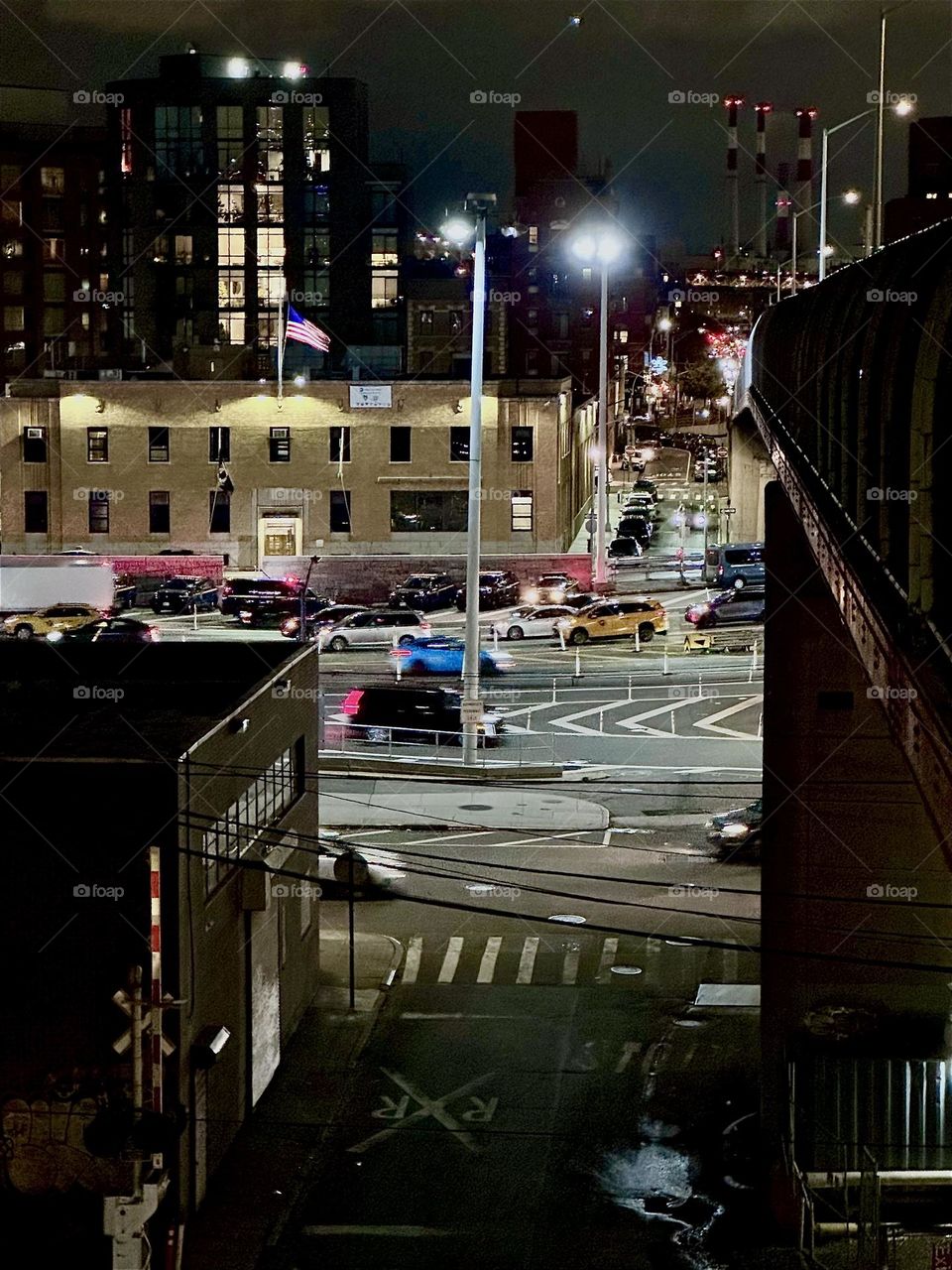 This is “Borden Avenue” and “11th Street” by the “Pulaski Bridge” at “Newtown Creek” in LIC, Queens hustling and bustling with evening time traffic that is zooming past incessantly. 2023. Hypnotic Productions