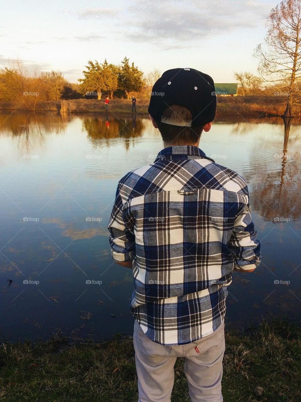 Young Men fishing in an East Texas Pond in Fall at Golden Hour