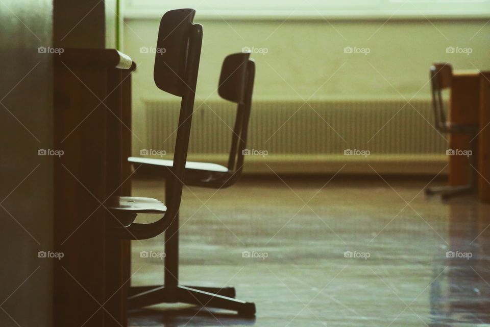 Chairs in an empty schools hallway.