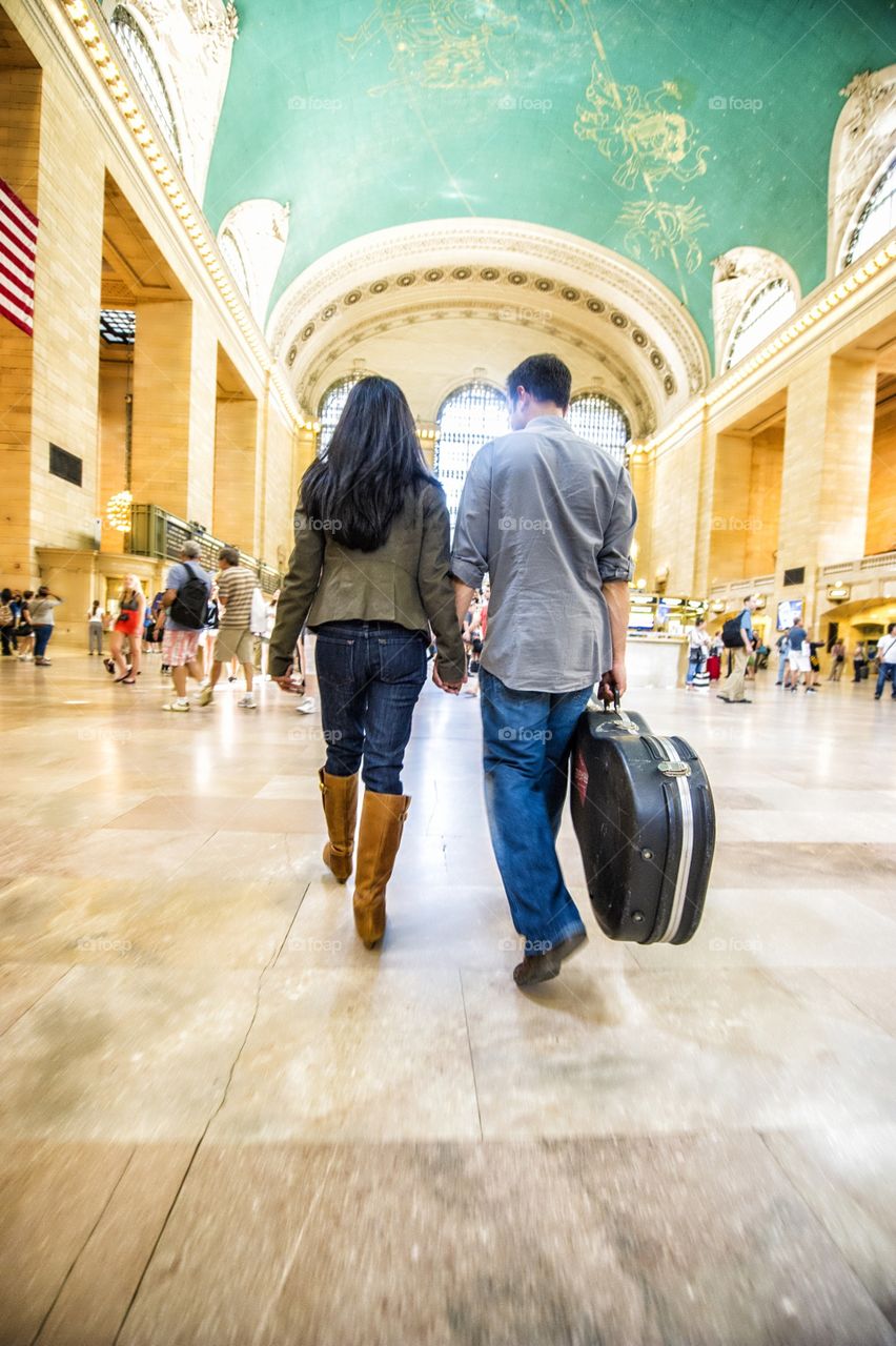 Couple walking through Grand Central station in NYC