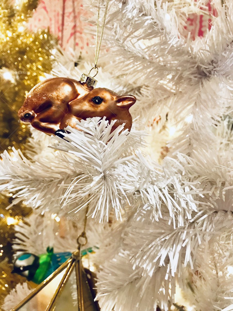 A bambi decoration in a white christmas tree