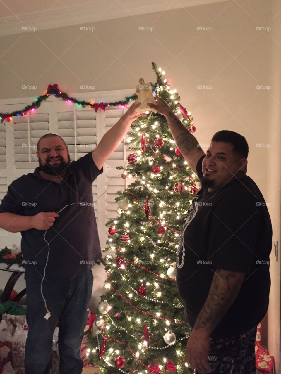 Putting the angel on the Christmas tree 