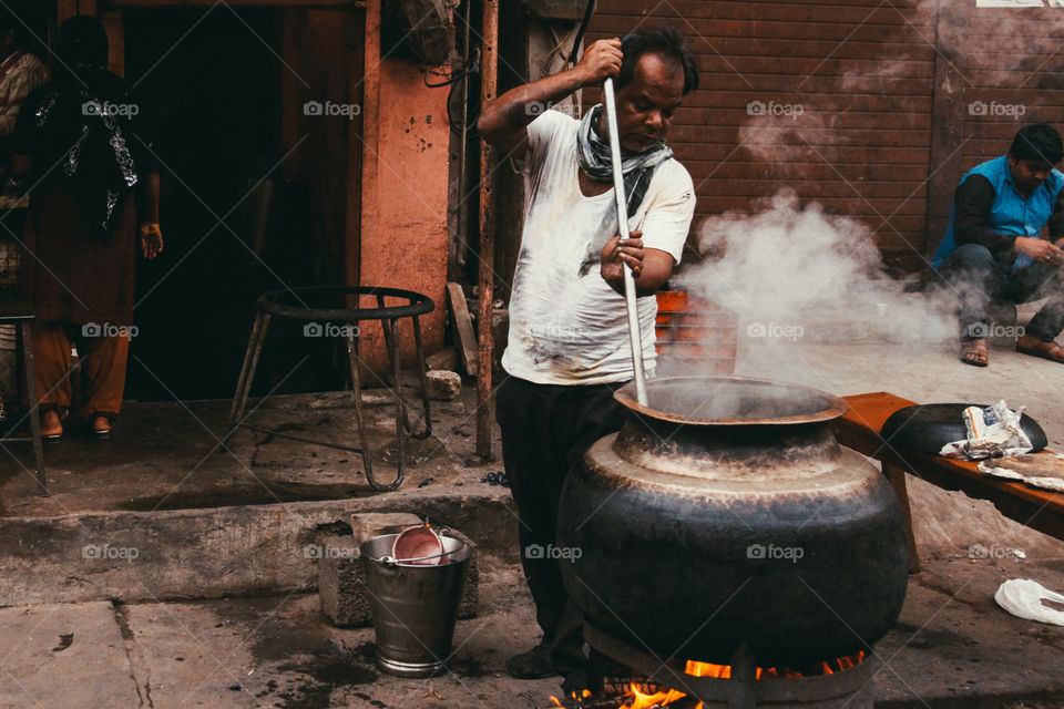 A street vendor prepares food in the streets of Jaipur, India.