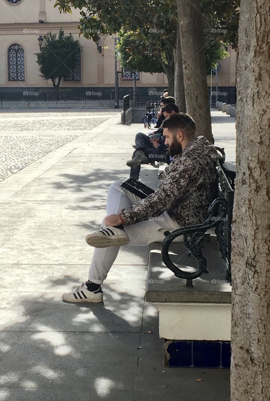 Young men reading in city