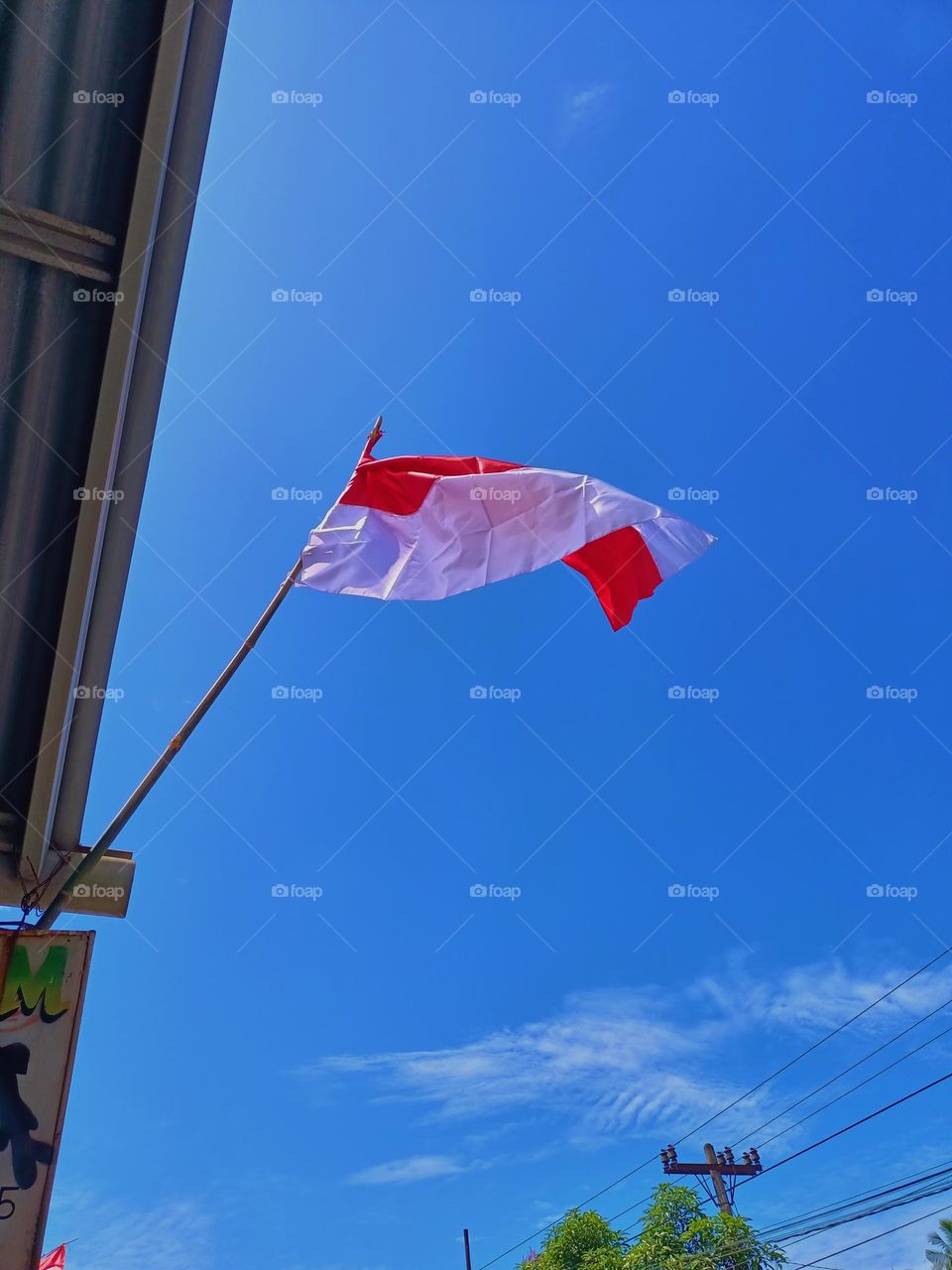 Red and white flag on a bamboo pole at the Indonesia's independence day