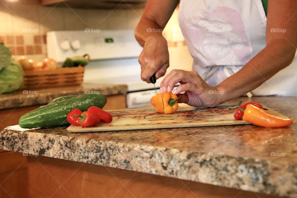 Woman cutting vegetables for dinner as part of daily routine