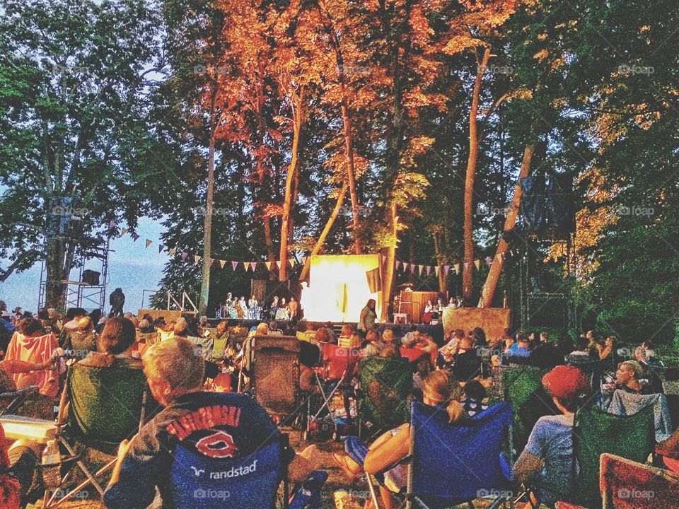 Audience looking musical performance during dusk