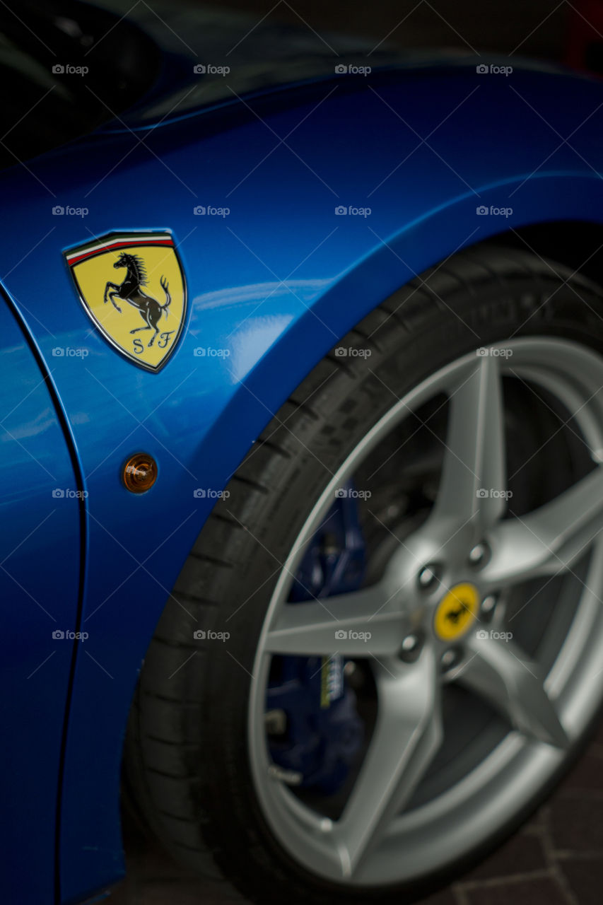 Blue Ferrari 488 spider coupe sports car 3.9 liter V8 twin turbo charged  (F154CB V8) close up logo and rim