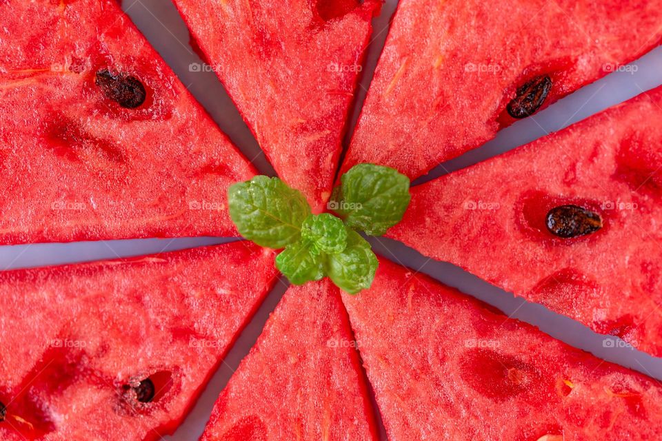 Fresh slices of watermelon with mint leaves, macro closeup. Summer food.