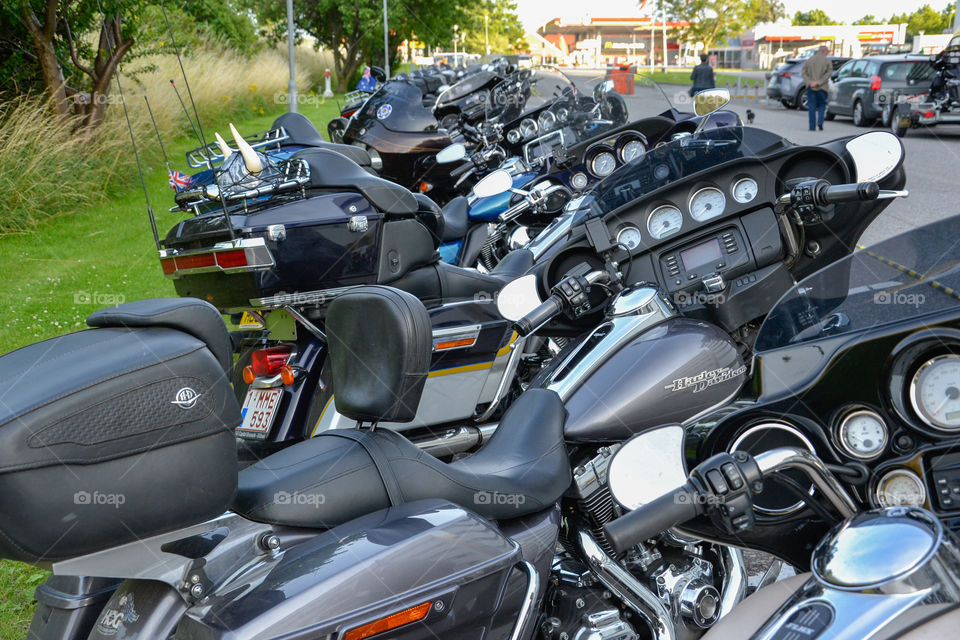 a large collection of motorcycles parked outside a hotel in Denmark.