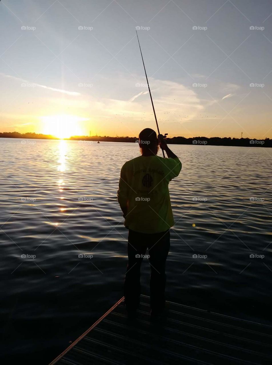 Sunrise fishing silhouette