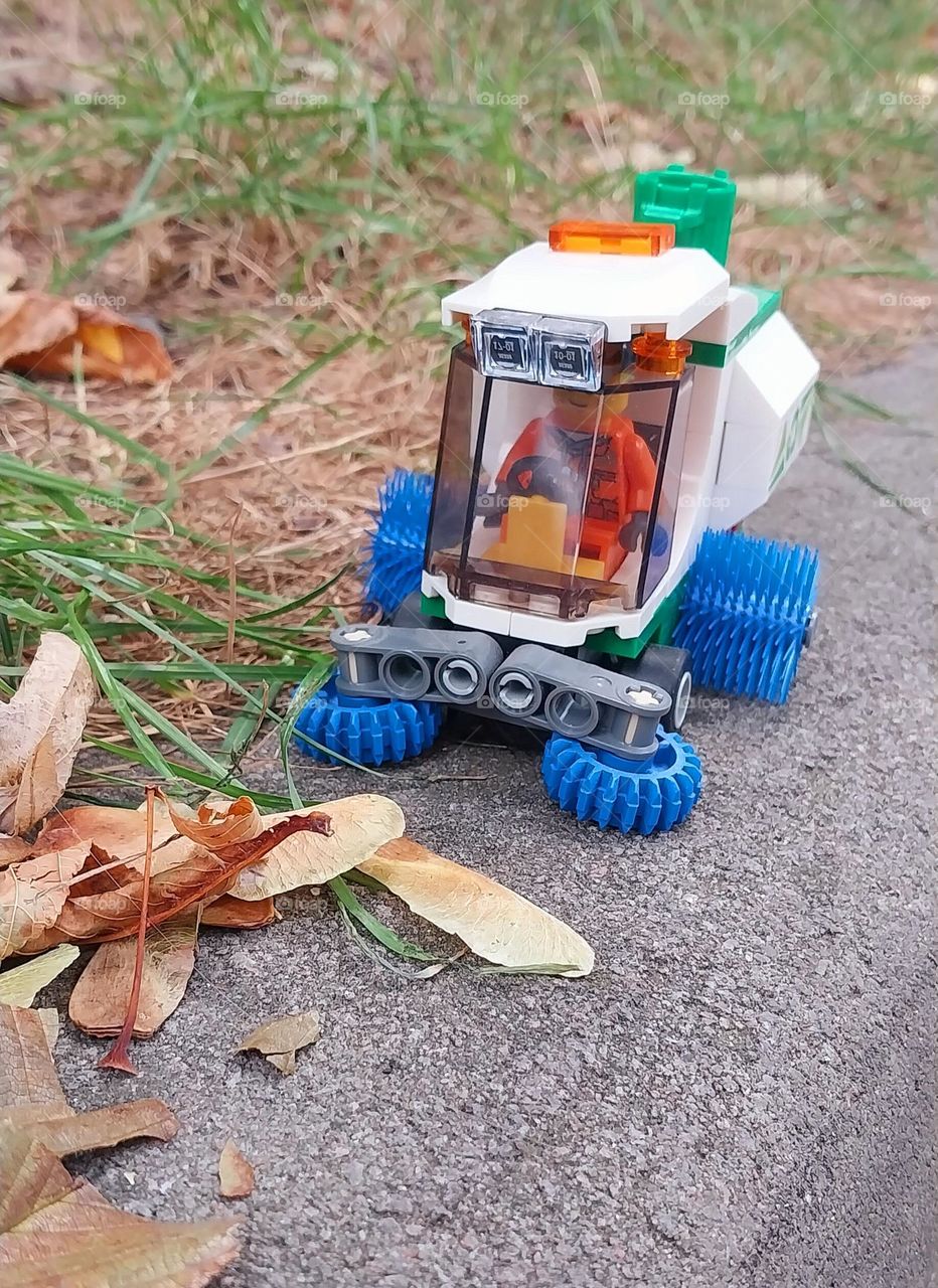 cleaning the street with the help of a little lego car