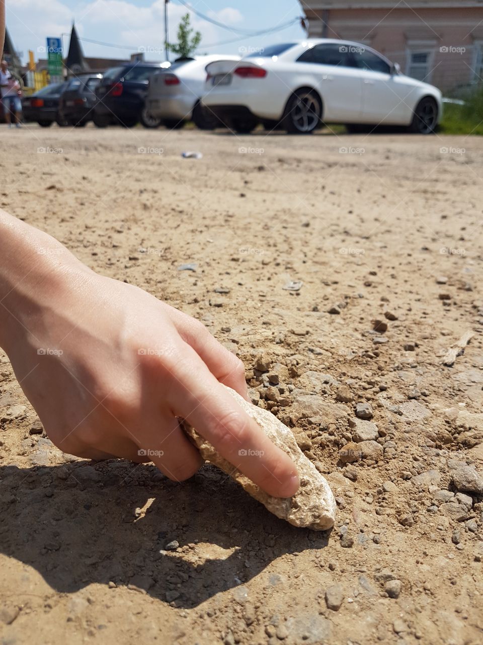 kids hand with little stones