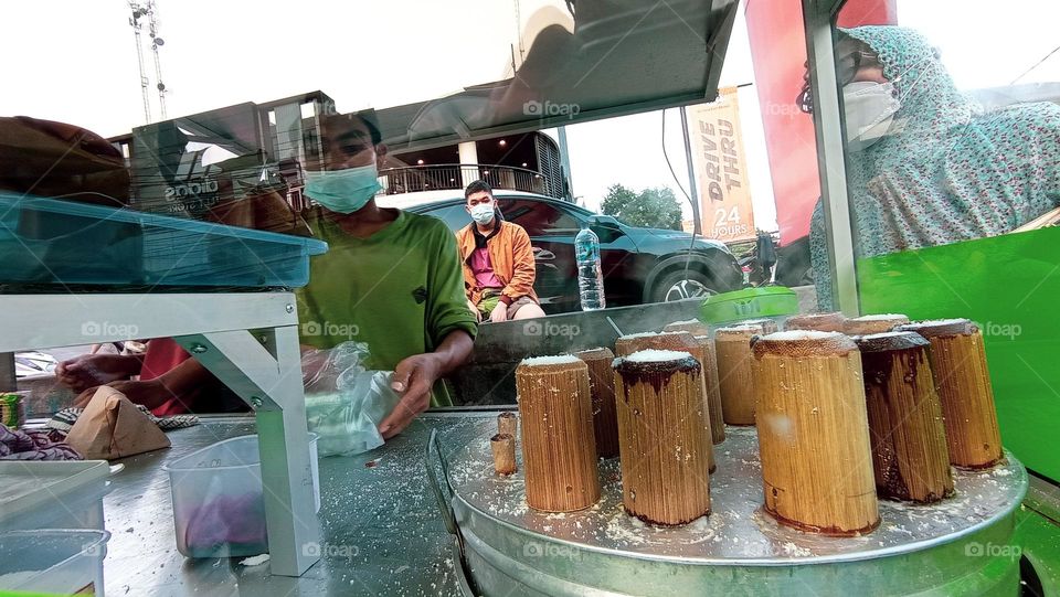 Portrait of Putu Cake, a typical Indonesian street food that is processed by inserting it into pieces of bamboo and steaming it in a pan on the stove. Healthy Food For Vegan.