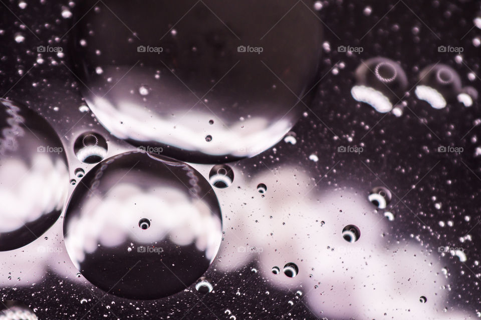 Small bubbles of vegetable oil in water close-up.