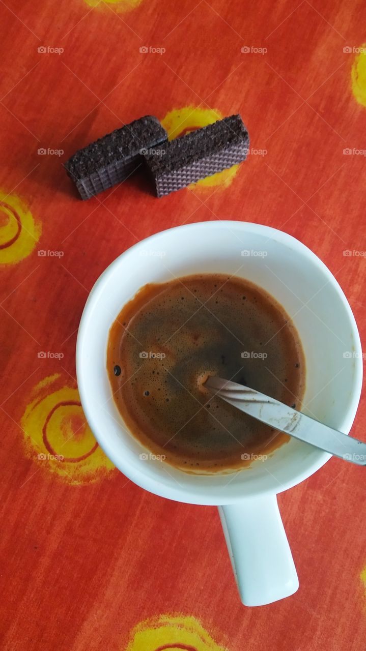 a cup of coffee and two biscuits