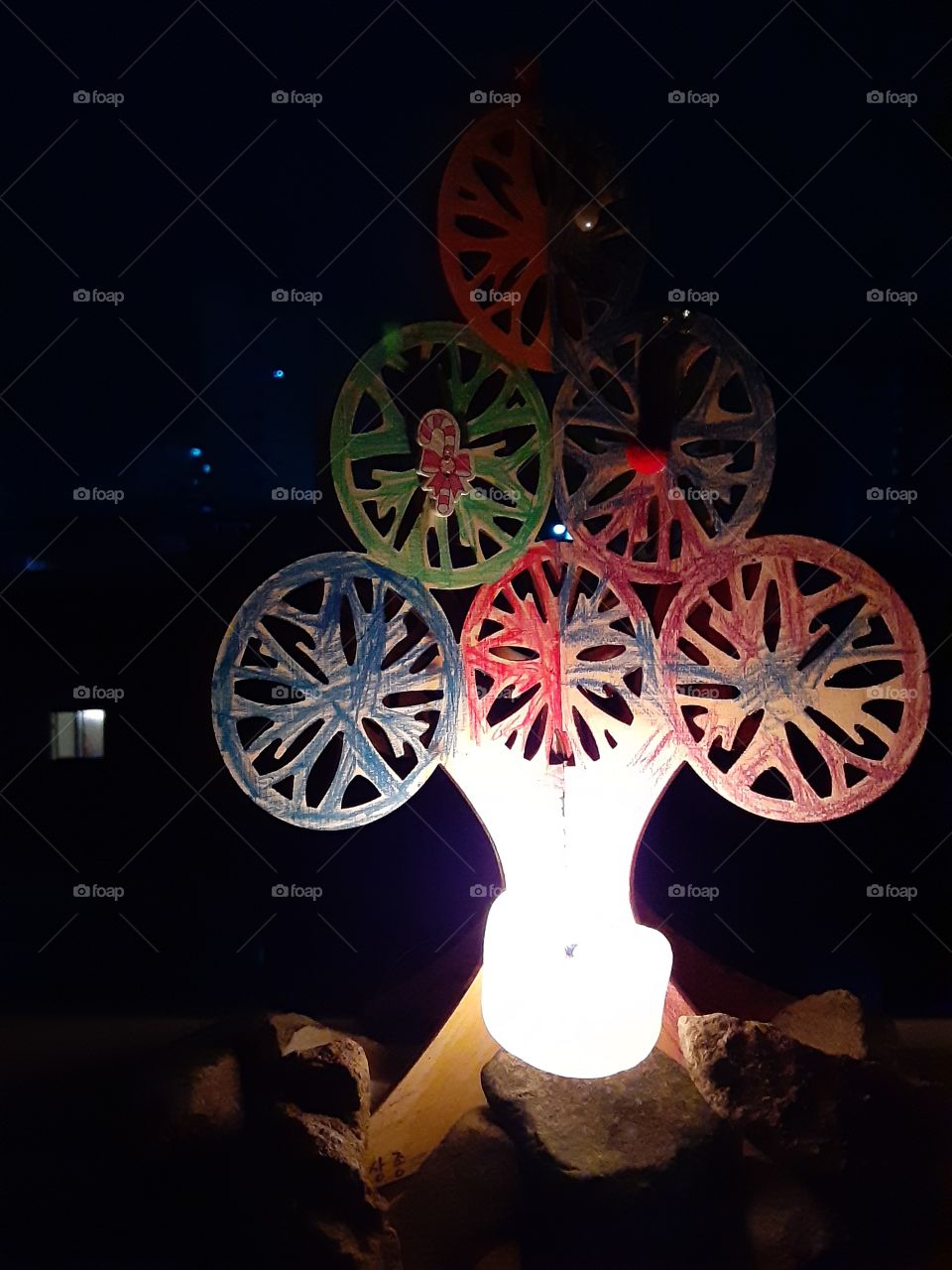 this is a paper Christmas tree which is formed like a snow flakes. it looks simple but it looks great when i put light on it at night.
