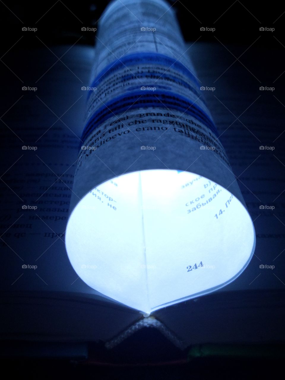 Glowing circle from a sheet in a book on a black background