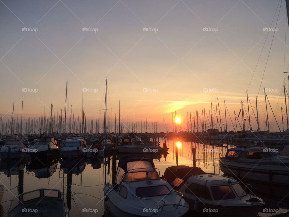 Boats in a harbour in sunrise