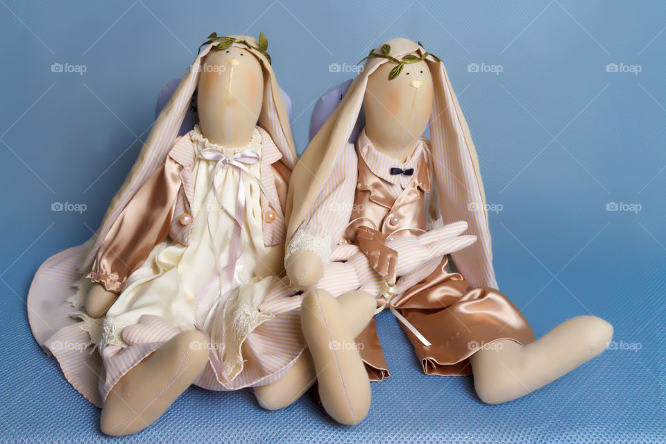 Two toy rabbits is sitting, handmade