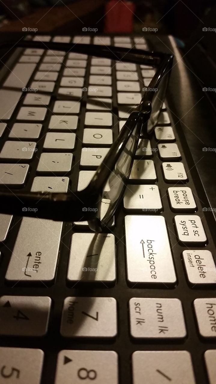 my glasses resting on the keyboard of my laptop