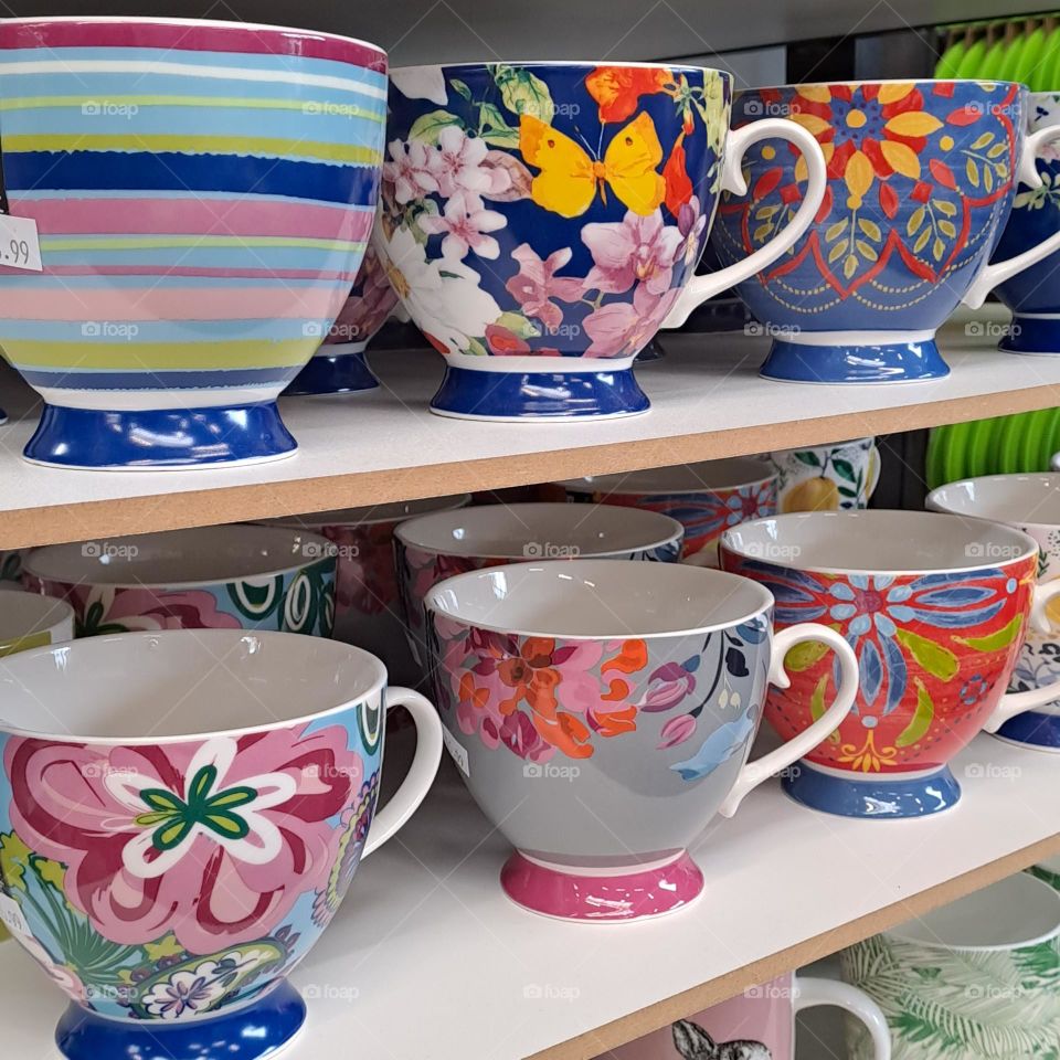 colourful mugs on shelves. shopping store