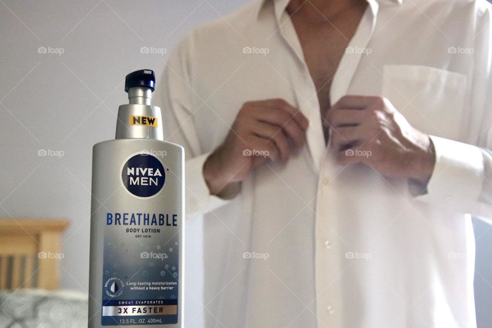 Nivea men with man in background  buttoning shirt 