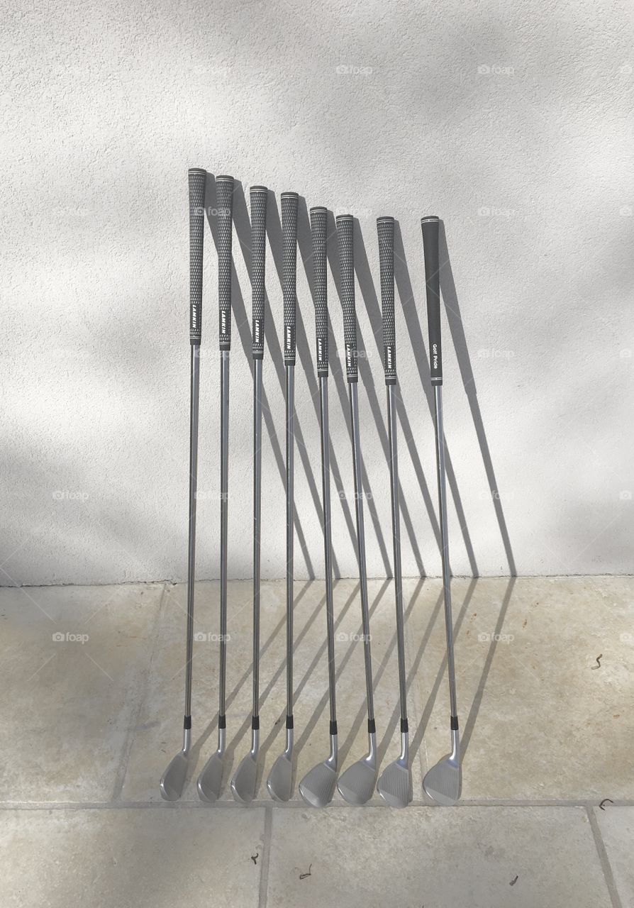 Golf clubs on a wall