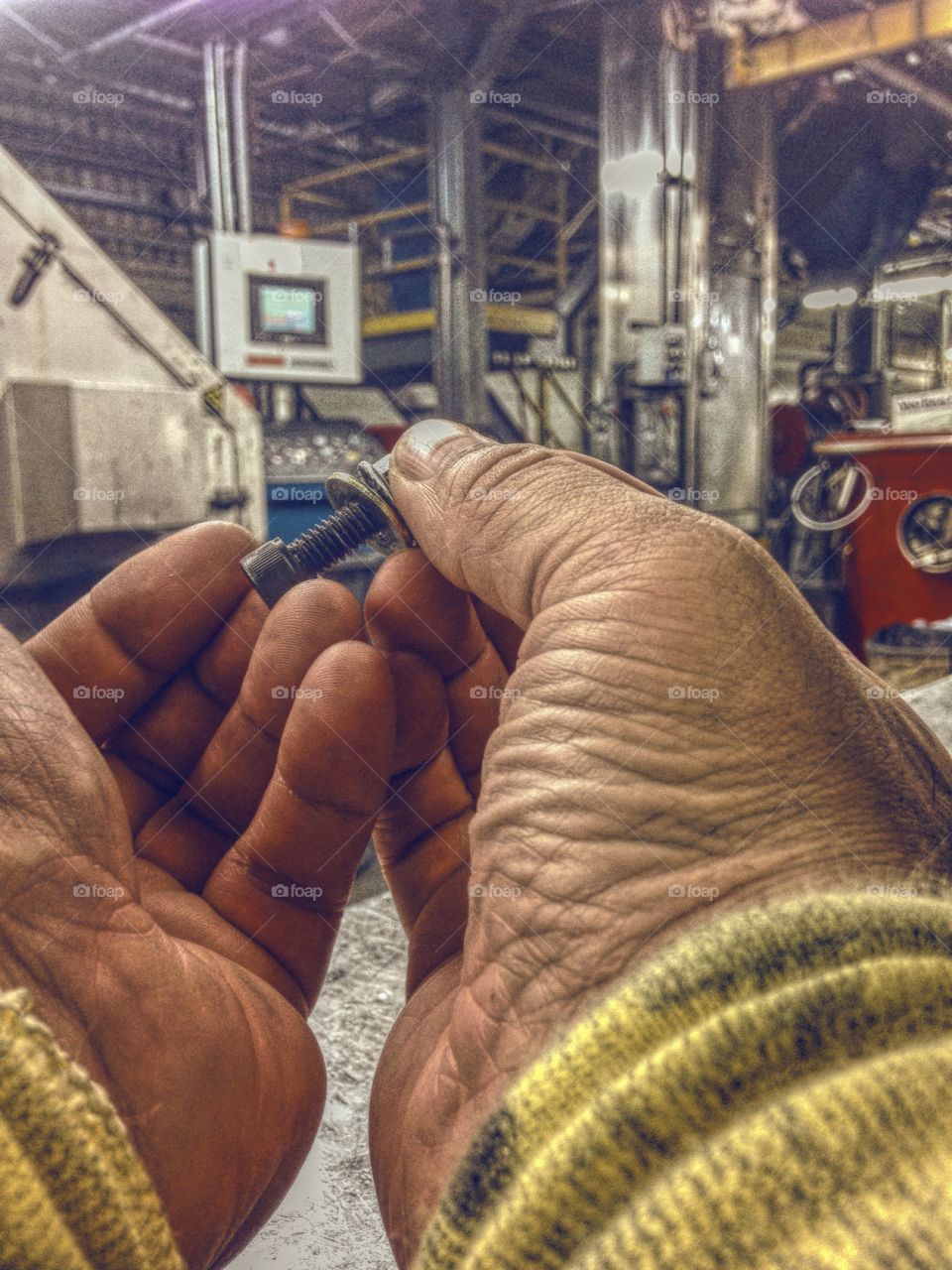 Close-up of person hands holding nut bolt