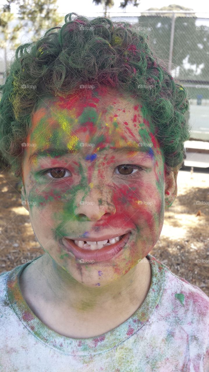 Portrait of a boy with holi colors in his face