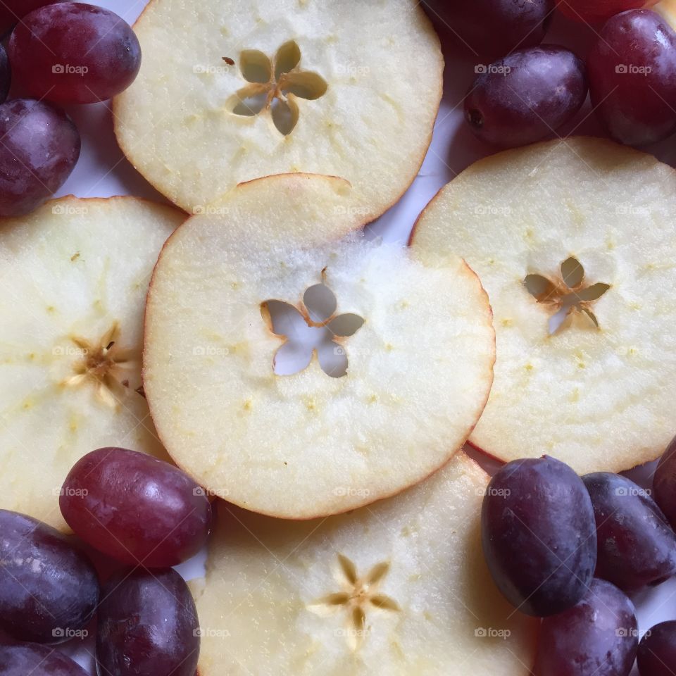 Sliced apple with red grape