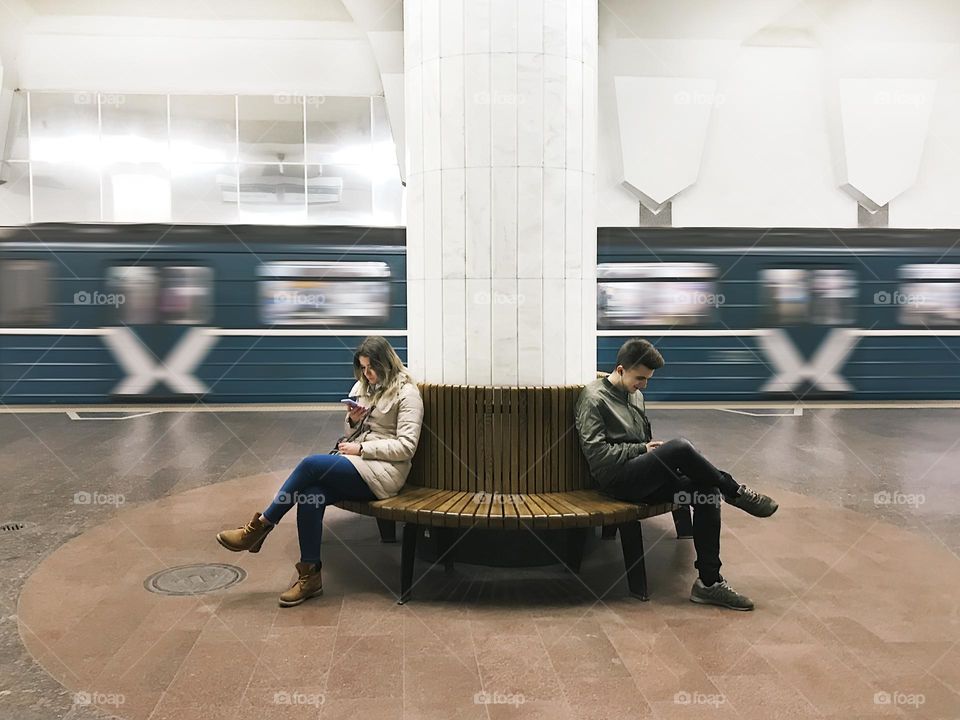 Using mobile phone at subway station 