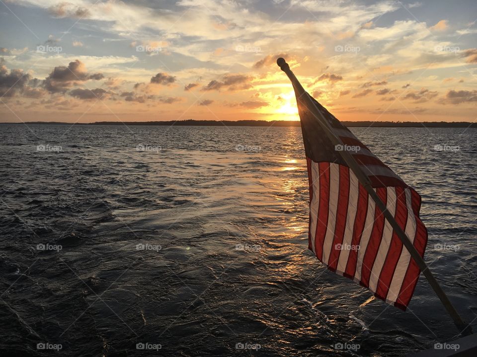 Gorgeous sunset for a backdrop with Old Glory proudly waving at the front. God Bless America! 