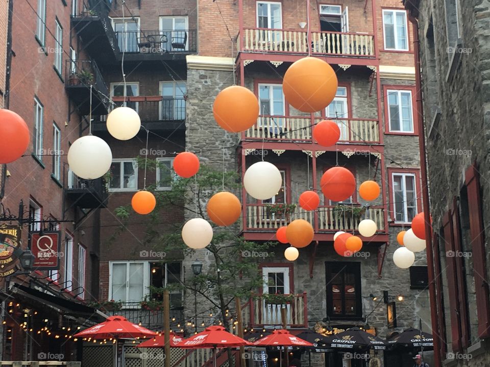 Orange and white balloons flying over a cafe in quebec city canada north america beautiful spring day