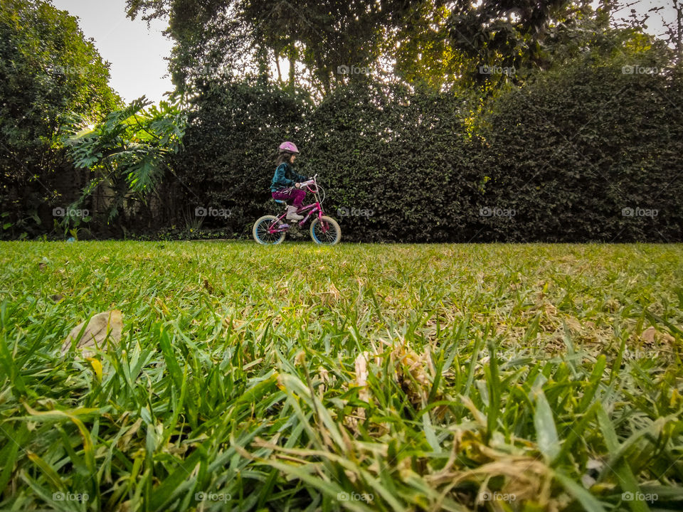 girl riding het bike with helmet on