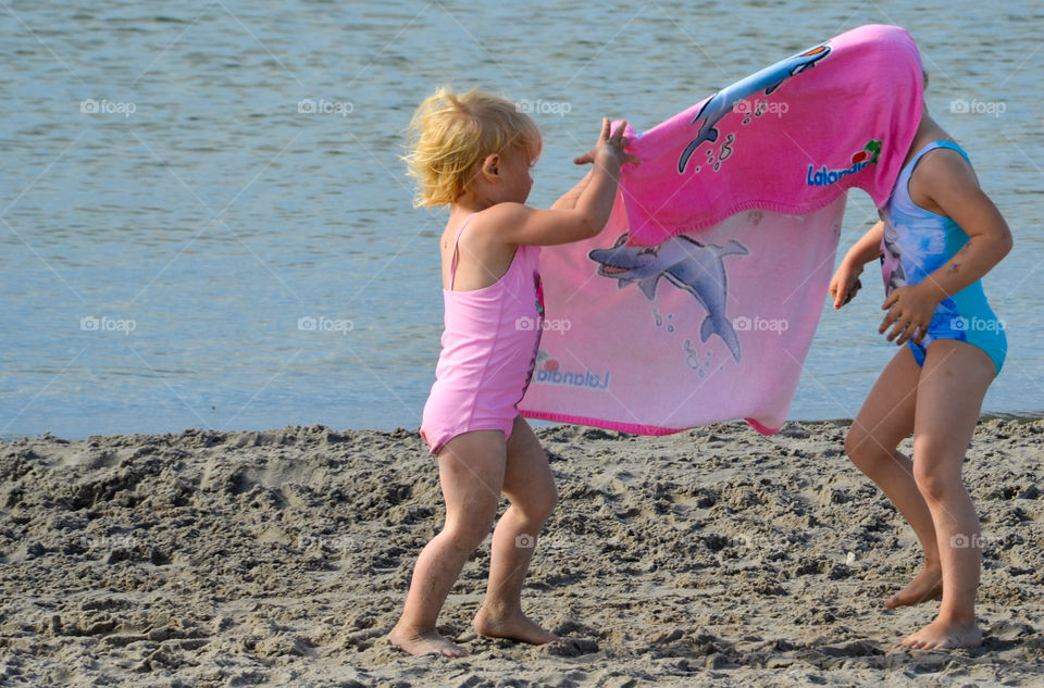 Young sisters playing on the beach Ribban in Malmö Sweden.