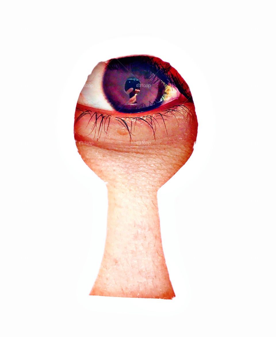 Close-up of person looking through keyhole