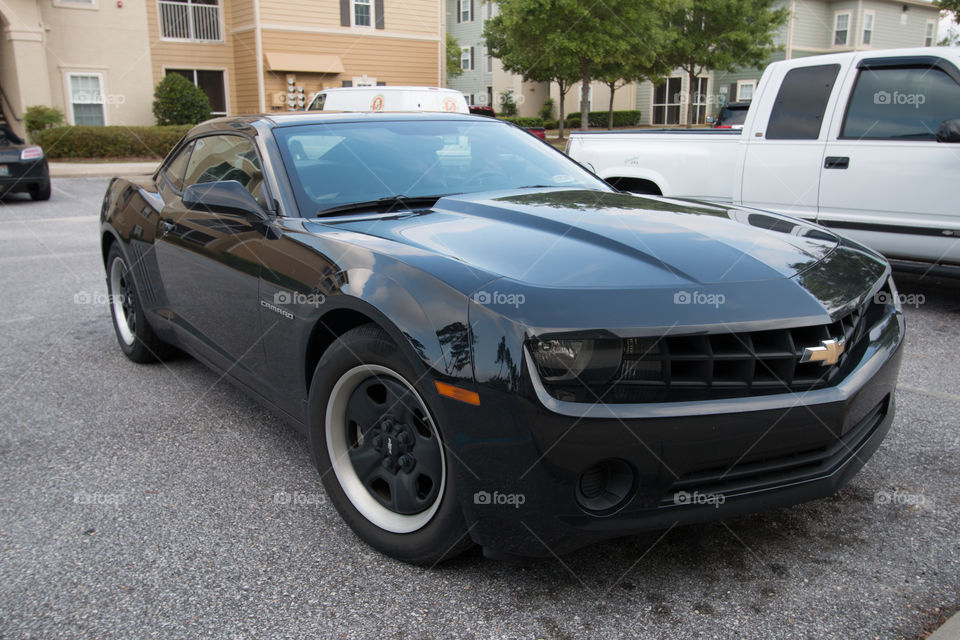 Chevrolet camaro car parking in the parking lot near the apartment 