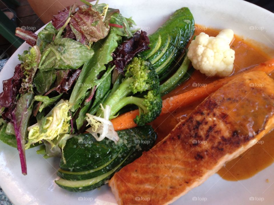 Salmon with a citrus orange sauce and healthy fresh steamed vegetables