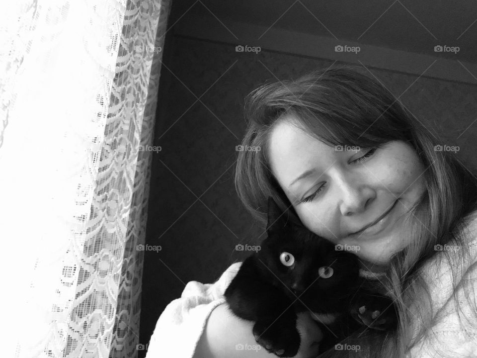 Black and white photography of a girl and her cat.