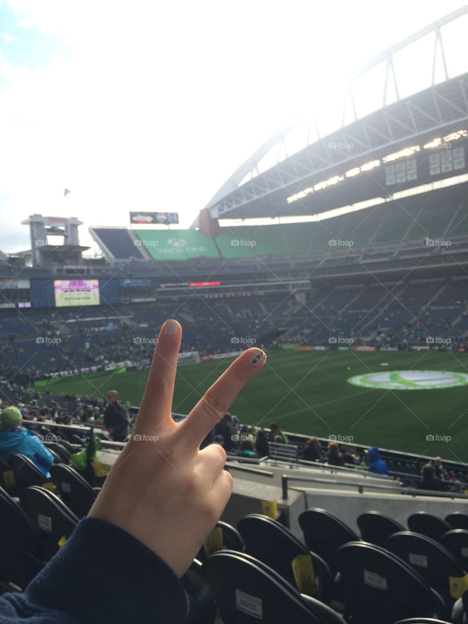 A peace sign at a sports stadium