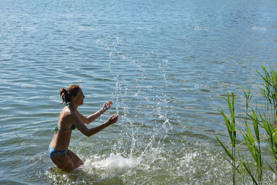 woman in swimsuit in the water lake, magic summer time