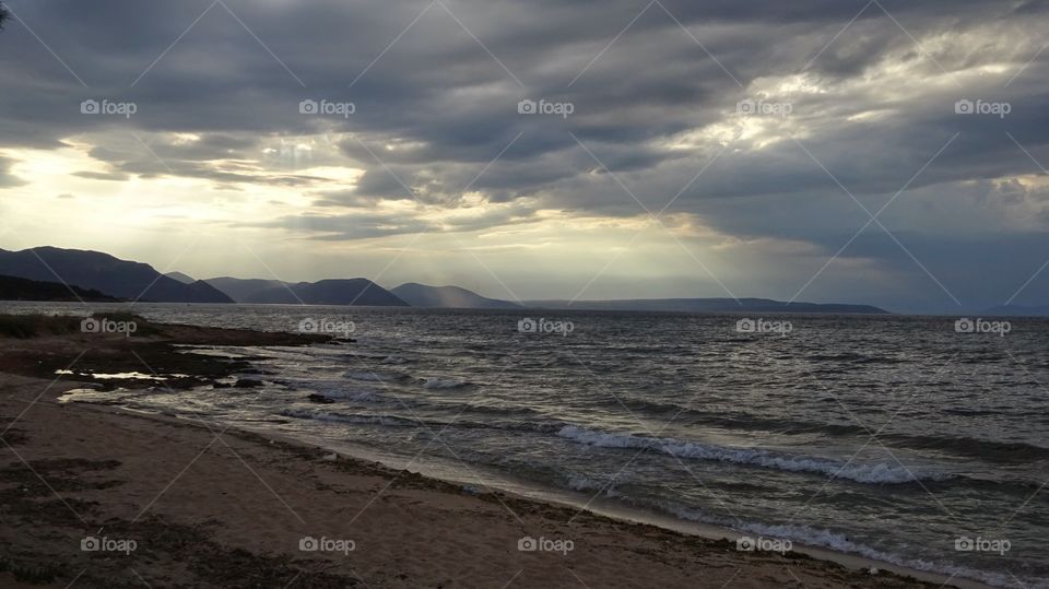 Scenic view of a beach against cloudy sky
